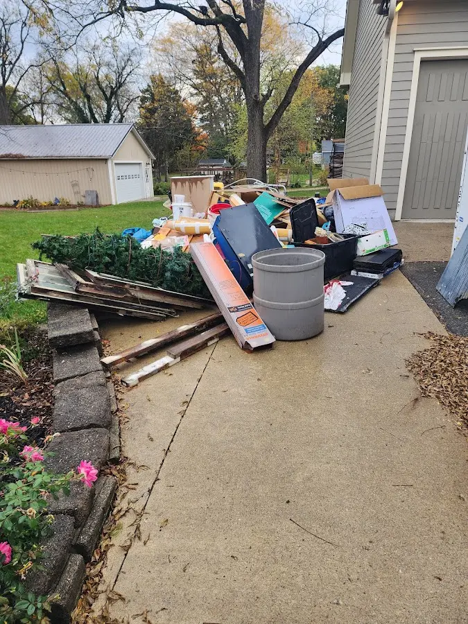 Dumpster being loaded with debris for Roofing Dumpster Rental in Ben Lomond
